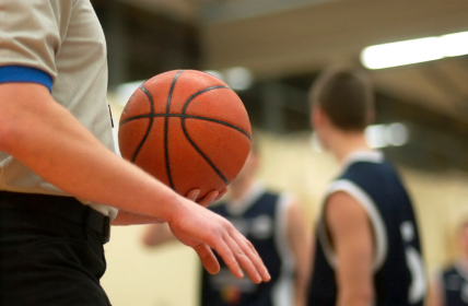 Basketball referee holding ball