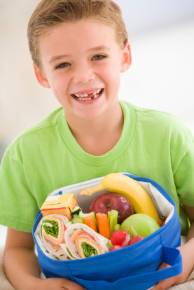 Gap toothed child with nutritious lunch