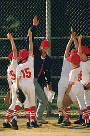 Coach celebrating with team with high fives