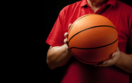 MomsTeam coach holding a basketball