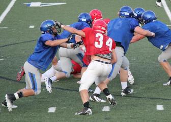 Hands to face mask during football scrimmage