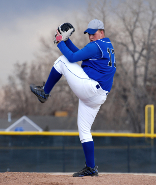 Baseball pitcher winding up to throw