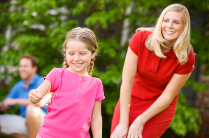 Mom watching daughter holding sparkler