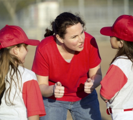 Mom 
	coaching girls in T-ball