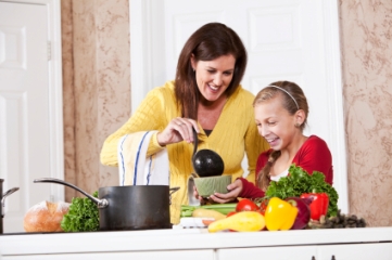 Mother and daughter making healthy soup