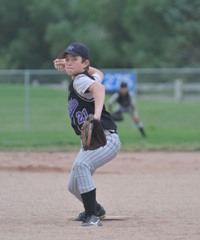 Youth baseball pitcher winding up to throw curveball