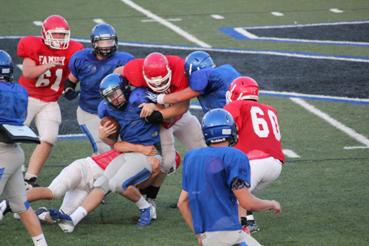 Football player being tackled in scrimmage