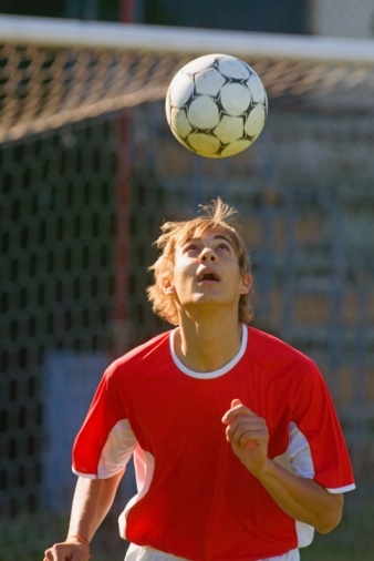 Soccer player juggling ball on head