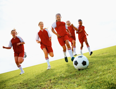 Soccer players chasing ball