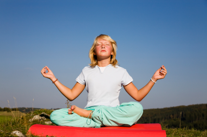 Young girl practicing yoga outside