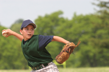 Young pitcher cocking arm to throw curve ball