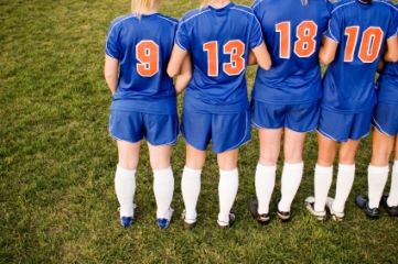 Female soccer players forming wall