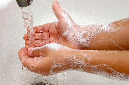 Boy washing hands in sink