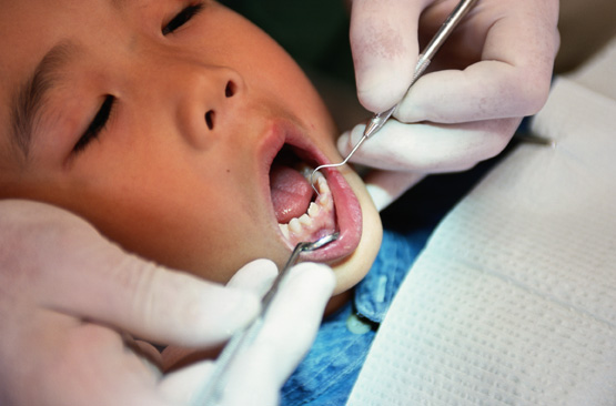 Dentist examining child's teeth