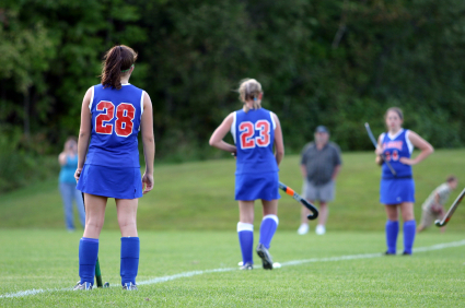 Girls playing field hockey