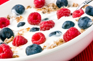 Cereal with raspberries and blueberries and milk