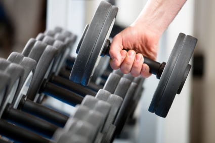 Man picking up dumbell