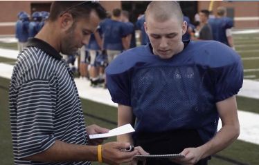 Athletic trainer testing football player