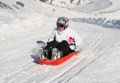 Sledder with helmet